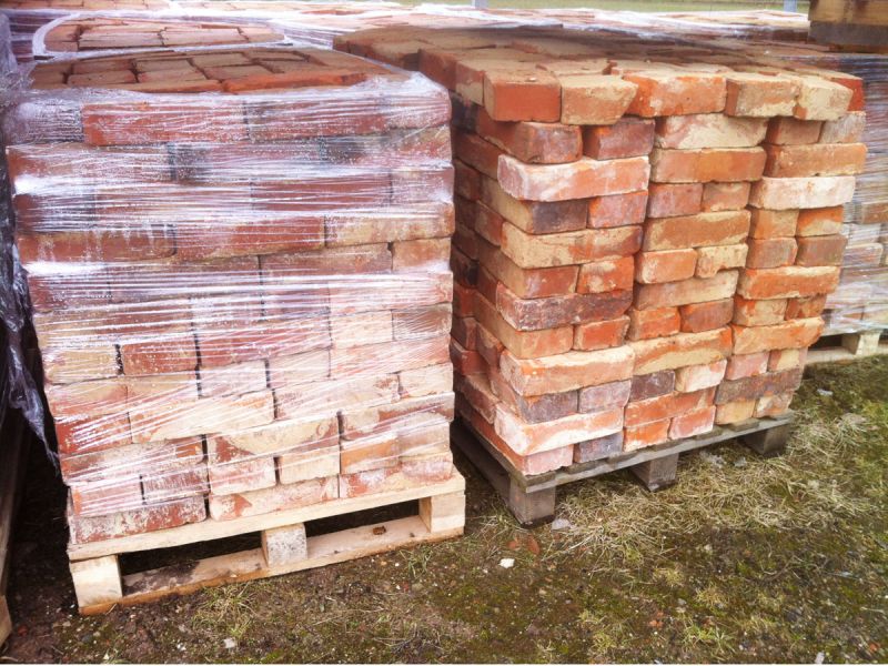 Eingeschweißte Backsteine auf Paletten warten auf ihren Abtransport